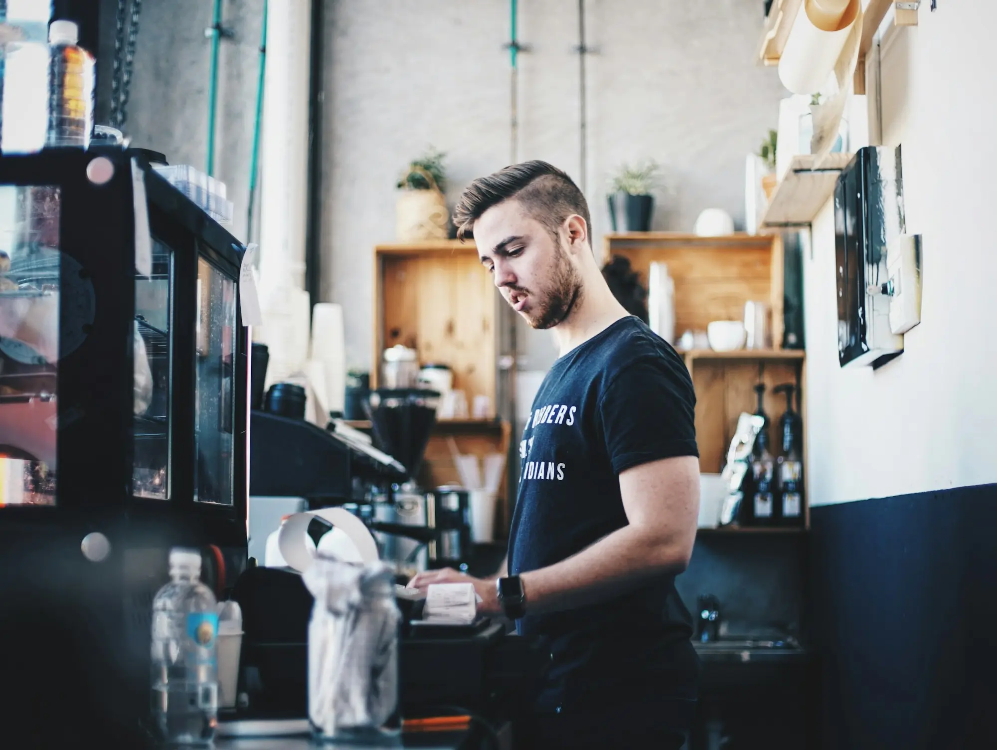 Cafe owner working the espresso machine in a Melbourne coffee shop