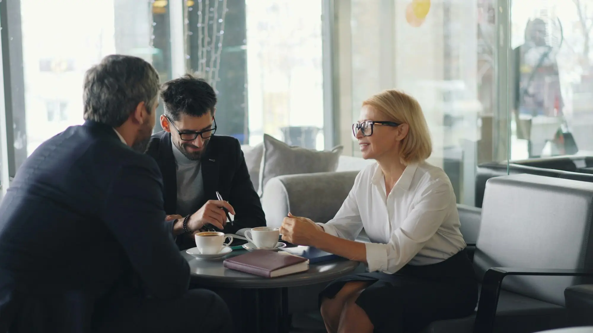 Business owner discussing a loan decision with advisers