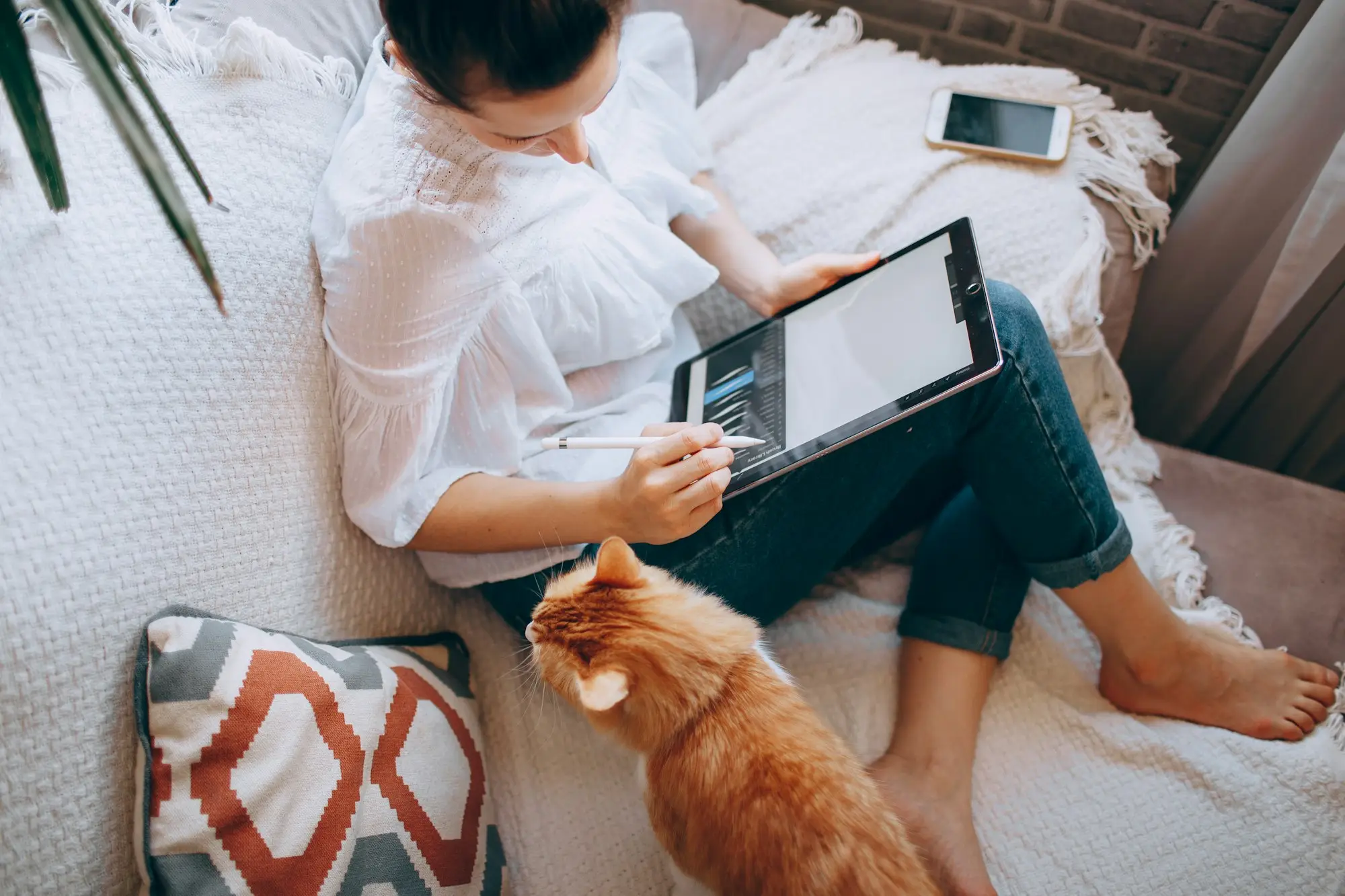 Business owner doing her weekly money routine on a tablet at home