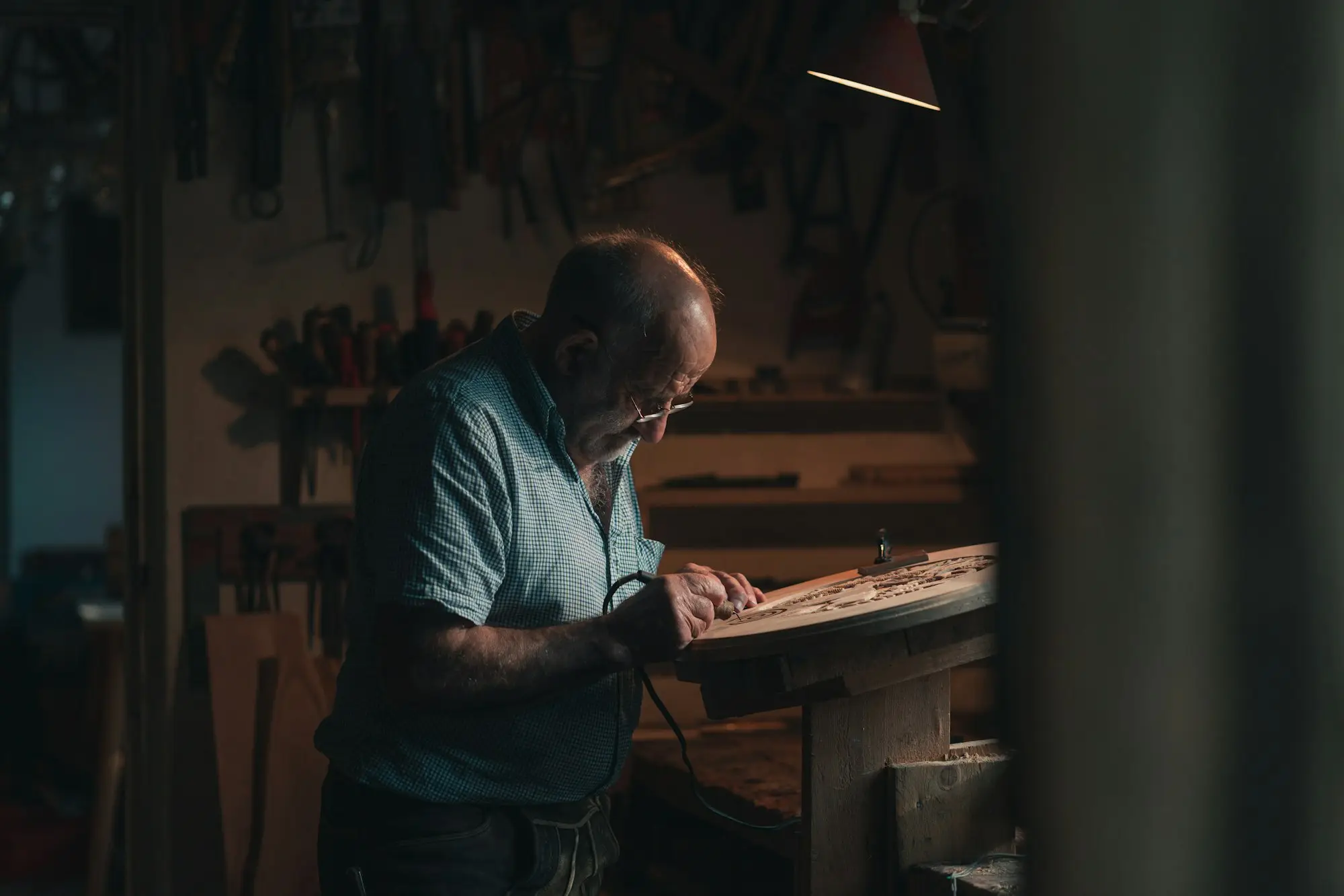 Workshop owner thinking at his bench about a big new customer